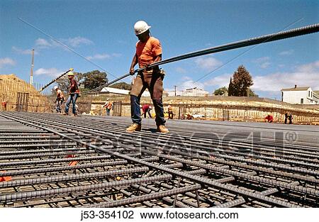 Ironworker carrying long rebar. I-880 Cypress project. Oaklnad, California. USA. View Large Photo Image Stock Image - Ironworker carrying long rebar. I-880 Cypress project. Oaklnad, California. USA.. Fotosearch