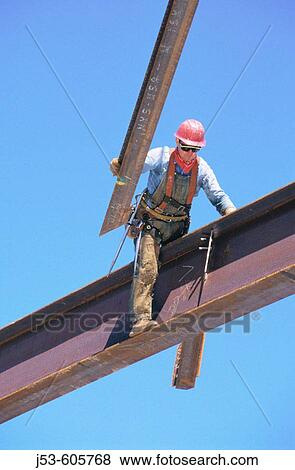 Ironworker guiding beam into position View Large Photo Image Stock Photo - Ironworker guiding beam into position. Fotosearch