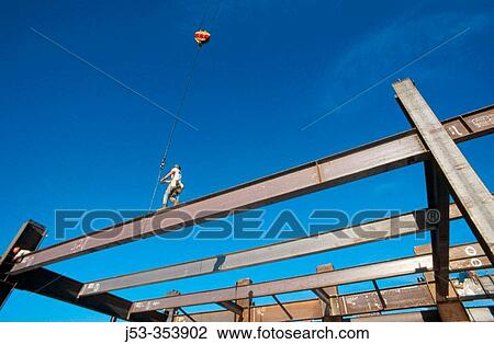 Stock Image - Ironworker, steel high rise framing. Sacramento. California. USA.. Fotosearch