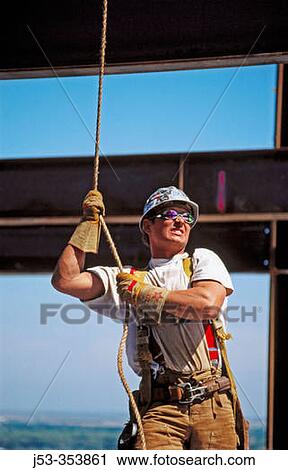 Stock Image - Ironworker,? Tagman?. Esquire plaza building. Sacramento, California. USA.. Fotosearch