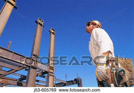 Ironworker working on structural steel building View Large Photo Image Stock Photo - Ironworker working on structural steel building. Fotosearch