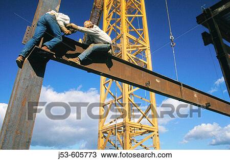Ironworkers connecting steel beams View Large Photo Image Stock Image - Ironworkers connecting steel beams. Fotosearch