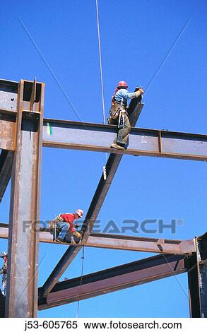 Stock Photography - Ironworkers hanging structural steel. Fotosearch