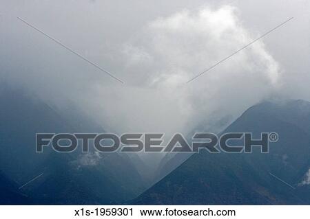 Island of Maui shrouded by clouds. View Large Photo Image Stock Image - Island of Maui shrouded by clouds.. Fotosearch