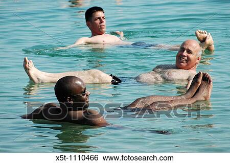 Israel, Dead Sea tourists floating in the water View Large Photo Image Stock Photograph - Israel, Dead Sea tourists floating in the water. Fotosearch
