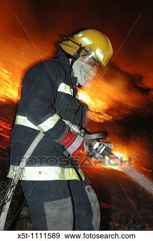 Israel, Haifa Carmel Mountain Forest, fire fighter fighting the flames View Large Photo Image Stock Photo - Israel, Haifa Carmel Mountain Forest, fire fighter fighting the flames. Fotosearch