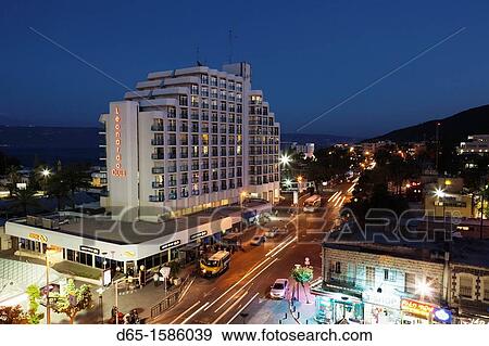 Israel, The Galilee, Tiberias, HaBanin Street and Leonardo Club Hotel, dusk View Large Photo Image Stock Photo - Israel, The Galilee, Tiberias, HaBanin Street and Leonardo Club Hotel, dusk. Fotosearch