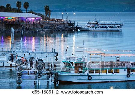 Israel, The Galilee, Tiberias, Sea of Galilee-Lake Tiberias, tourist boat, lakefront, dusk View Large Photo Image Stock Image - Israel, The Galilee, Tiberias, Sea of Galilee-Lake Tiberias, tourist boat, lakefront, dusk. Fotosearch