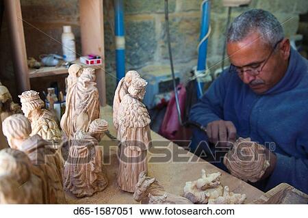 Stock Image - Israel, West Bank, Bethlehem, Arab Christian artisan making wooden religious figures, R, MR-ISL-11-003. Fotosearch