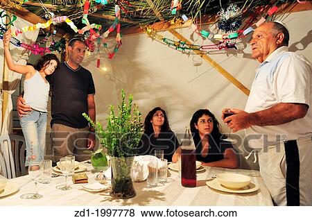 Israeli Jewish family celebrating the Jewish holiday of Sukkoth. View Large Photo Image Stock Photo - Israeli Jewish family celebrating the Jewish holiday of Sukkoth.. Fotosearch