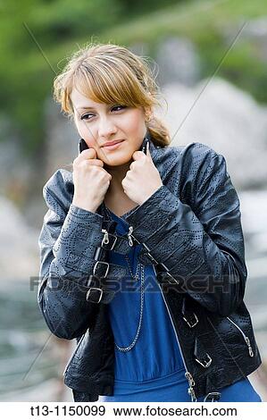Stock Photo - It is cold for young woman wearing Black jacket. Fotosearch