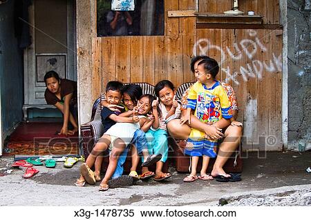 Stock Photography - It is comon to see families living, and children playing on dangerously unsanitary illegal trash dumps on the resort island of Bali, Indonesia Illness is reampant and life expectance is very low in these conditions. Fotosearch