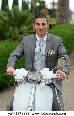 Stock Photo - Italian bridegroom on a Vespa scooter, Firenze, Tuscany, Italy. Fotosearch