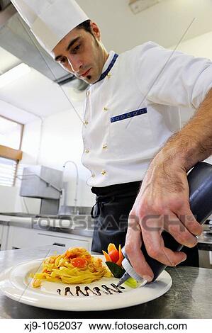 Stock Photo - Italian cook who prepares noodles. Fotosearch