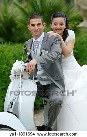Picture - Italian wedding couple on a motor scooter Vespa, Firenze, Tuscany, Italy. Fotosearch