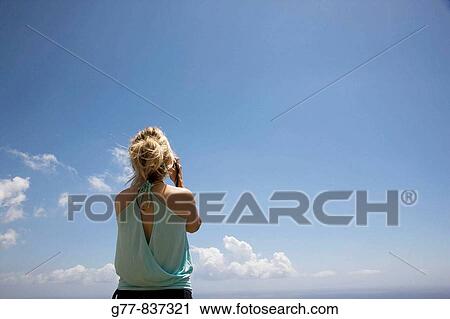 Stock Image - Italy Liguria Cinque Terre Vernazza Woman taking pictures MODEL RELEASE 1108. Fotosearch