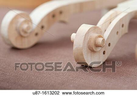 Italy, Lombardy, Cremona, Violin Maker Worshop, Close up of Violin Scrolls Unvarnished View Large Photo Image Stock Image - Italy, Lombardy, Cremona, Violin Maker Worshop, Close up of Violin Scrolls Unvarnished. Fotosearch
