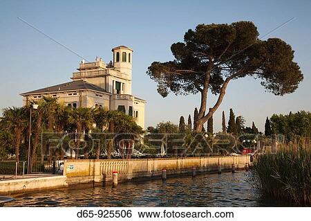 Stock Photograph - Italy, Lombardy, Lake District, Lake Garda, Sirmione, lakeside villa. Fotosearch