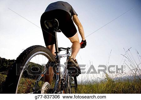 Stock Photograph - Italy Pedimont Lake Maggiore Young man on mountain bike MODEL RELEASE 1112. Fotosearch