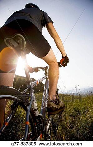 Stock Photography - Italy, Pedimont, Lake Maggiore. Young man on mountain bike. Fotosearch