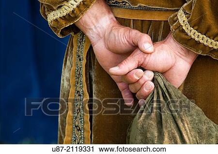Stock Image - Italy, Piedmont, Historical Reenactment Mediaeval,, Man in Medieval Costume, Hands.. Fotosearch