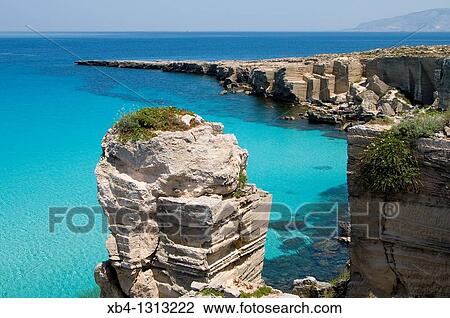 Stock Image - Italy, Sicily, Favignana island, Cala Rossa, Tuff cliffs. Fotosearch