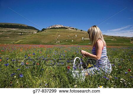 Italy, Umbria, Norcia, Castelluccio di Norcia, Woman in poppies field View Large Photo Image Stock Photo - Italy, Umbria, Norcia, Castelluccio di Norcia, Woman in poppies field. Fotosearch