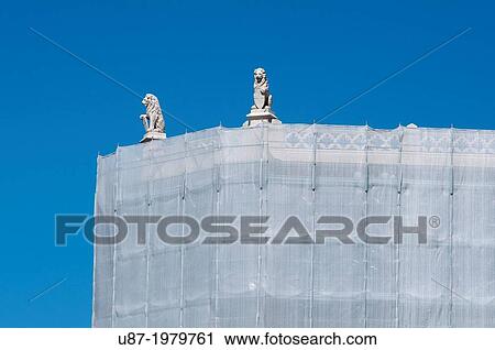 Stock Image - Italy, Veneto, Padua, Piazza delle Erbe Square, Scaffolding and Statue.. Fotosearch