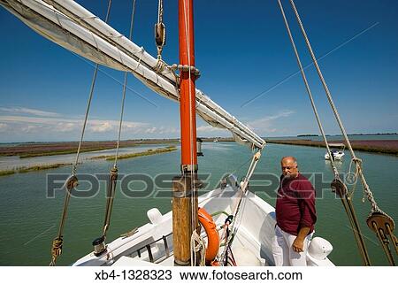 Italy, Venice, cruising the lagune with Eolo, a traditional Venetian fishing boat called? bragozzo?. View Large Photo Image Stock Image - Italy, Venice, cruising the lagune with Eolo, a traditional Venetian fishing boat called? bragozzo?.. Fotosearch