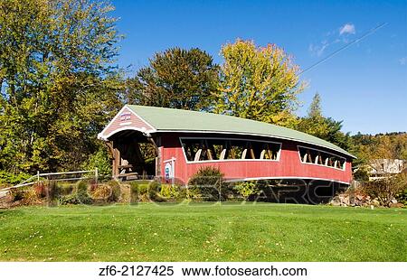 Stock Photography - Jackson New Hampshire Curved Covered Bridge in Wentworth Country Club in Northern New England in fall foliage in October.. Fotosearch
