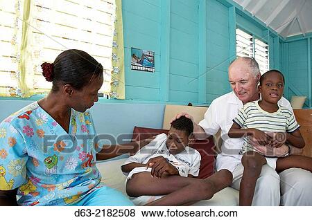 Jamaica. American Catholic missionary priest visiting sick children. View Large Photo Image Stock Photo - Jamaica. American Catholic missionary priest visiting sick children.. Fotosearch