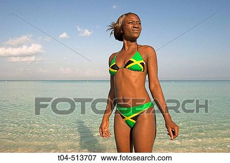 Jamaican woman in bikini with Jamaican flag on beach. Negril. Jamaica. View Large Photo Image Stock Photo - Jamaican woman in bikini with Jamaican flag on beach. Negril. Jamaica.. Fotosearch