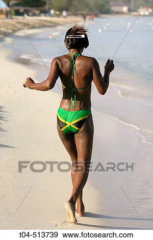 Jamaican woman in bikini with jamaican flag on beach. Negril. Jamaica. View Large Photo Image Stock Photo - Jamaican woman in bikini with jamaican flag on beach. Negril. Jamaica.. Fotosearch
