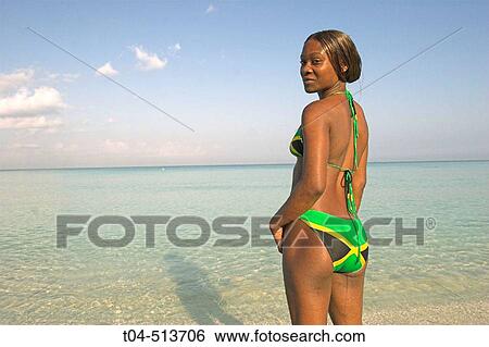 Jamaican woman in bikini with Jamaican flag on beach. Negril. Jamaica. View Large Photo Image Stock Photograph - Jamaican woman in bikini with Jamaican flag on beach. Negril. Jamaica.. Fotosearch