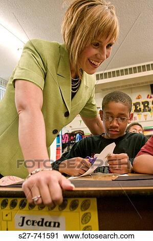 Jamie Otto, a fifth grade teacher at Robinwood Elementary School, helps Jordan Waters during class. She has been selected the Ferguson_Florissant School District Teacher of the Year. View Large Photo Image Stock Image - Jamie Otto, a fifth grade teacher at Robinwood Elementary School, helps Jordan Waters during class. She has been selected the Ferguson_Florissant School District Teacher of the Year.. Fotosearch