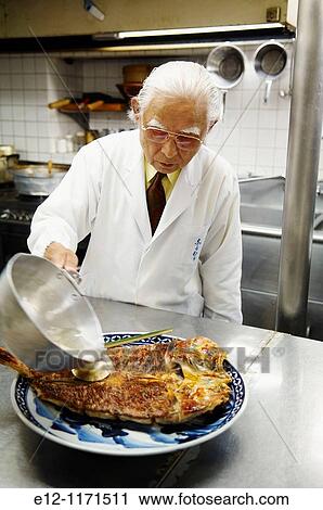 Japan, Kyoto, Ryotei Nakamura, Bunji Nakamura actual fixing grilled bream of Akashi, pouring sake & broth in the end. View Large Photo Image Stock Image - Japan, Kyoto, Ryotei Nakamura, Bunji Nakamura actual fixing grilled bream of Akashi, pouring sake & broth in the end.. Fotosearch
