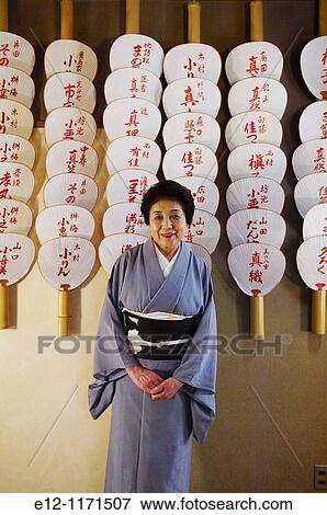 Japan, Kyoto, Ryotei Nakamura, chef Benji Nakamura's wife in front of geisha's fans. View Large Photo Image Stock Photo - Japan, Kyoto, Ryotei Nakamura, chef Benji Nakamura's wife in front of geisha's fans.. Fotosearch