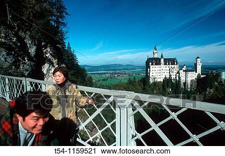 Japanese tourists on the bridge in front of Neuschwanstein Castle, Bavaria, Germany View Large Photo Image Stock Image - Japanese tourists on the bridge in front of Neuschwanstein Castle, Bavaria, Germany. Fotosearch