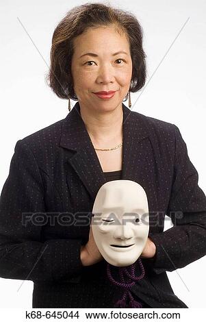 Japanese woman, late 50s, with mask. View Large Photo Image Picture - Japanese woman, late 50s, with mask.. Fotosearch