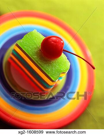 Jelly layer cake with a cherry on top View Large Photo Image Stock Photo - Jelly layer cake with a cherry on top. Fotosearch
