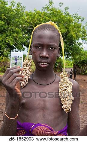 Jinka Ethiopia Africa village Lower Omo Valley Mago National Park young boy with new Fuji Polaroid tribe Mursi tribal portrait traditional culture 15 View Large Photo Image Stock Image - Jinka Ethiopia Africa village Lower Omo Valley Mago National Park young boy with new Fuji Polaroid tribe Mursi tribal portrait traditional culture 15. Fotosearch