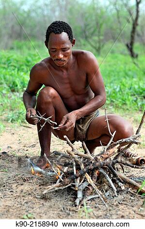 Stock Image - Jo/? hoansi San man making fire, Namibia, Africa.. Fotosearch
