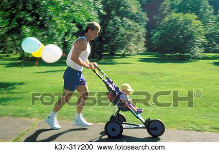 Stock Image - Jogger father with baby son sitting in stroller. Fotosearch