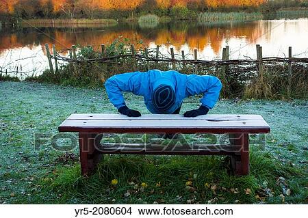 Jogger warming up at sunrise on a clear, frosty Autumnal morning in Cowpen Woodland Park Billingham, Cleveland, north east England, United Kingdom. View Large Photo Image Picture - Jogger warming up at sunrise on a clear, frosty Autumnal morning in Cowpen Woodland Park Billingham, Cleveland, north east England, United Kingdom.. Fotosearch
