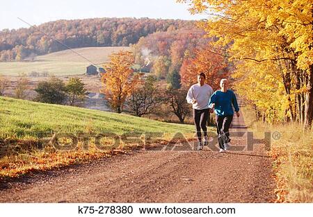 Jogging on country road in autumn View Large Photo Image Stock Image - Jogging on country road in autumn. Fotosearch