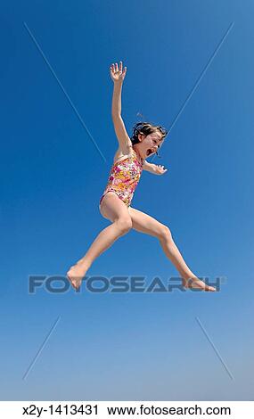 Jouful girl jumping, Ocean City, New Jersey, USA View Large Photo Image Stock Image - Jouful girl jumping, Ocean City, New Jersey, USA. Fotosearch