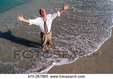 Jubilant senior businessman at beach View Large Photo Image Stock Photography - Jubilant senior businessman at beach. Fotosearch