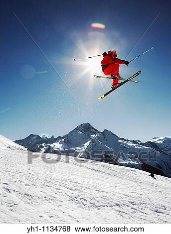 Jumping a red suit skieuren View Large Photo Image Stock Photo - Jumping a red suit skieuren. Fotosearch