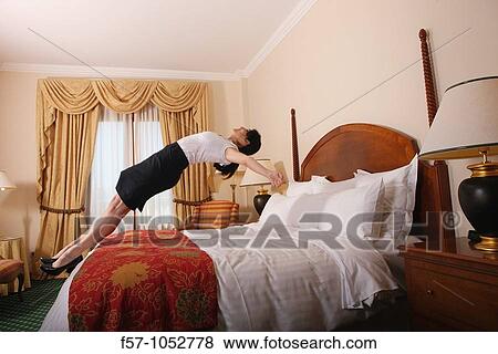 Jumping back on bed View Large Photo Image Stock Photo - Jumping back on bed. Fotosearch