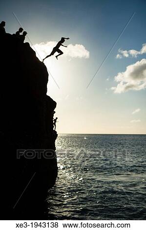 Jumping into water, Waimea Bay, Oahu, Hawaii. View Large Photo Image Stock Photo - Jumping into water, Waimea Bay, Oahu, Hawaii.. Fotosearch